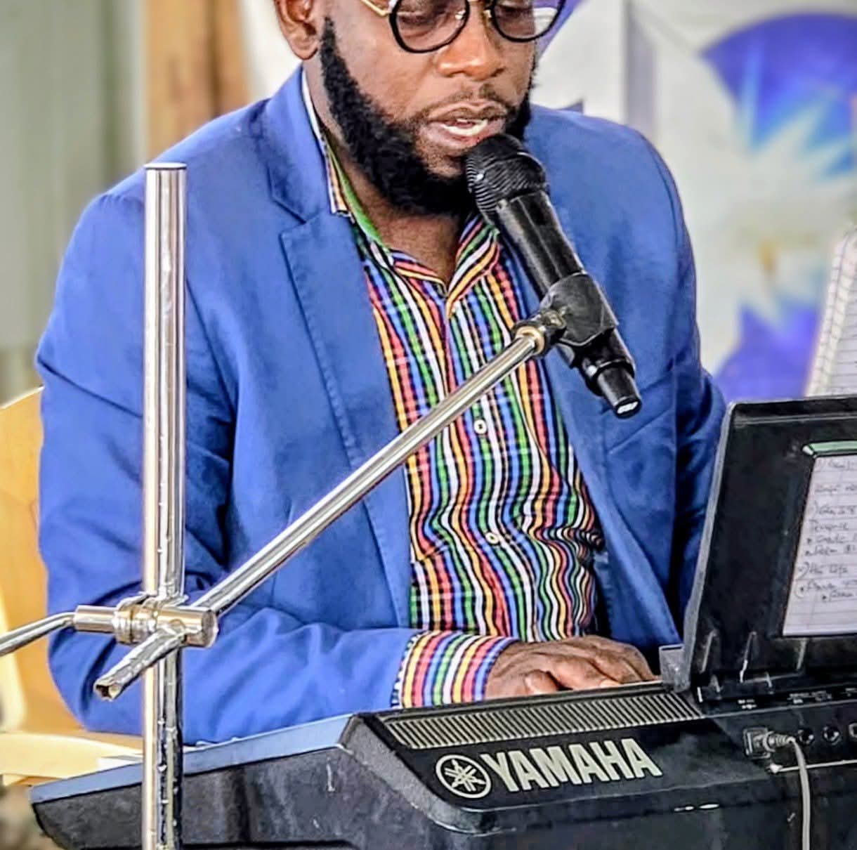 Pastor Nathan Kiama playing keyboard during worship