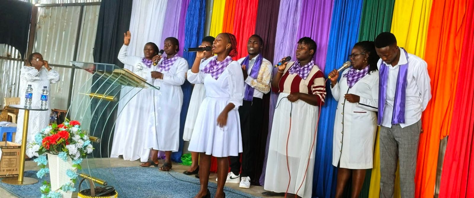 Praise and worship team singing in white